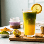 Natural Mounjaro recipe for weight loss detox drink with lemon, turmeric, and spirulina in a tall glass