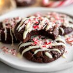 Close-up of delicious Gluten-Free Chocolate Peppermint Cookies drizzled with white chocolate and crushed candy canes.