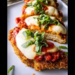 Three pieces of crispy Baked Chicken Parmesan topped with marinara sauce, melted mozzarella, and fresh basil.
