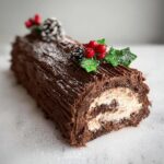 Close-up of a Classic Chocolate Christmas Yule Log showing the swirl of chocolate cake and cream filling.