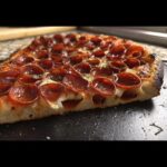 Close-up cross-section of Cup N’ Crisp Grilled Pepperoni Pizza showing cupped pepperoni and airy crust.