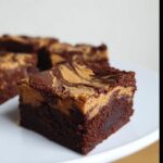 A close-up of a fudgy square of Peanut Butter Thermomix Brownies with a rich peanut butter swirl topping.