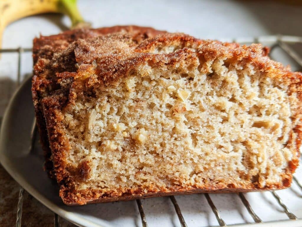 Close-up of a moist slice of Banana Bread With Ricotta showing its soft crumb and cinnamon sugar topping.