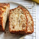 Close-up of moist Banana Bread With Ricotta slices showing a visible streak of banana in the center.
