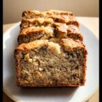 Close-up of thick slices of moist Best Ever Banana Bread with visible walnuts.