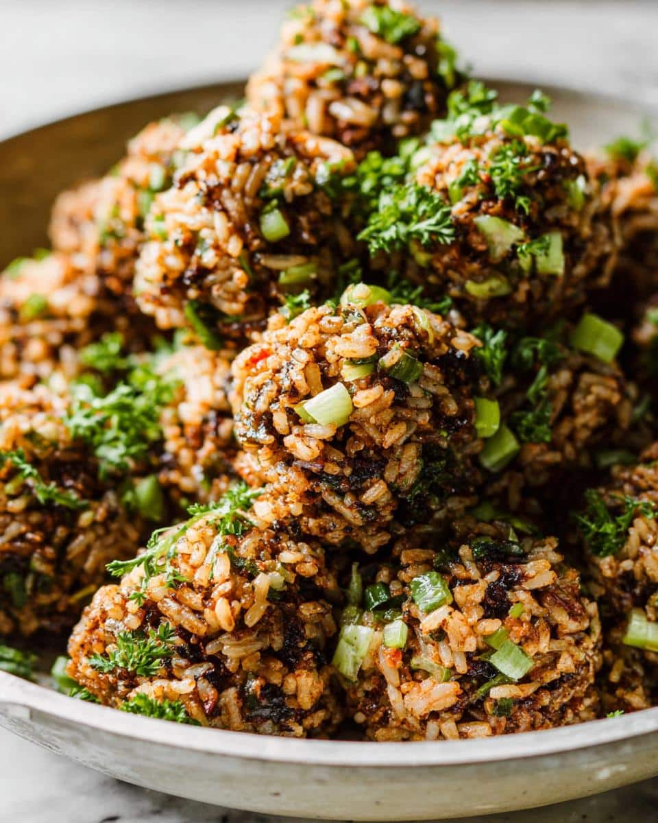 Close-up of several Louisiana Dirty Rice Bites, garnished with fresh green onions and parsley.