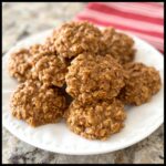 A stack of freshly made Peanut Butter No-Bake Cookies piled high on a white plate.