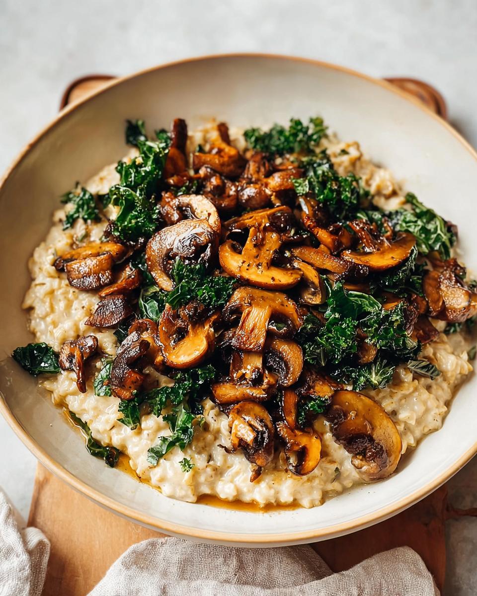 A bowl of creamy Savory Overnight Oats with Mushrooms and sautéed kale on top.